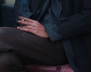 hand of old man smoking