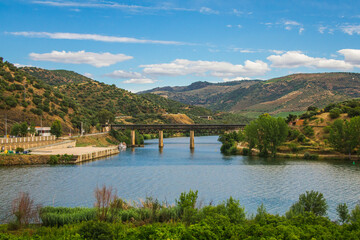 Fototapeta na wymiar Steel bridge over the Douro river, Portugal. Natural Park of the Douro river with beautiful mountain and river landscapes