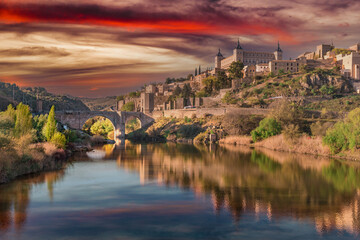 Toledo, Spain, March 27, 2019. Sunset view from the Tagus river towards the center of the city, a dreamy sky