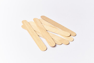 Tongue depressors isolated on white, also called abatelenguas or bajalenguas used by medical professionals for examination or for popsicles sticks
