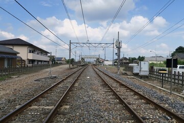 Fototapeta na wymiar Railroad from the rail crossing near Tomita Station in Ashikaga, Tochigi, Japan. June 24, 2021