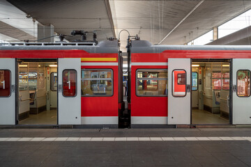 Train stop and opening automatic doors at platform railway station in Düsseldorf, Germany.