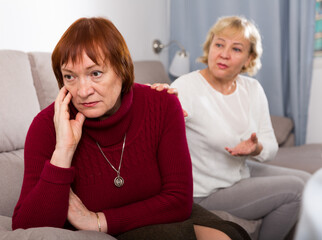 Two upset mature ladies finding out relationship at home