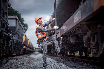 Engineer under inspection and checking construction process railway switch and checking work on railroad station .Engineer wearing safety uniform and safety helmet in work