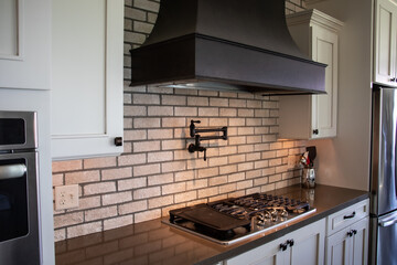 Traditional kitchen with vent hood and pot filler