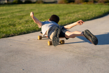 child riding playing on a skateboard in a park