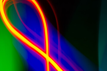 neon light motion on black. colorful abstract light background. shining light for decorating design as background and overlay to beautify a creative project.