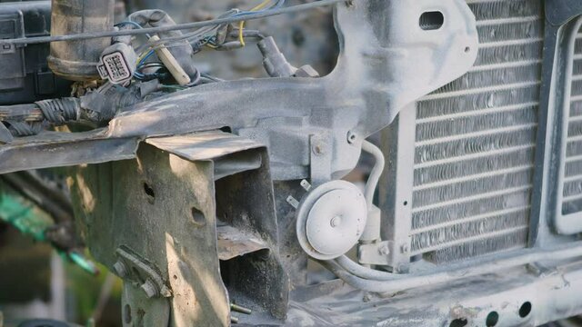 Rusted hulk wreck of radiator car machine engine partially, old metal abandoned car