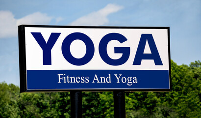 Yoga fitness studio sign with blue lettering.