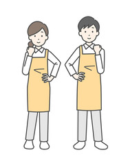 ガッツポーズをしているエプロン姿の男性と女性