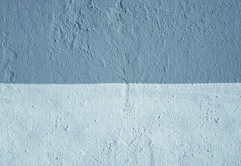 The wall is made of blue and light blue plaster.