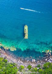 Ship Collecting Water from the Natural Spring off the mountain as another boat passes by no people...