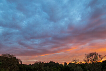 Early winter sunrise setting over the skyline of the forests on the Garden Route in South Africa