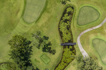 Golf course birds eye view of fairway golfing green sand pits lawn road house  path no people copy space