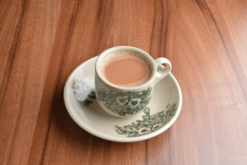 hot milk tea local Indian traditional teh Tarik in small cup on wood table hot beverage menu