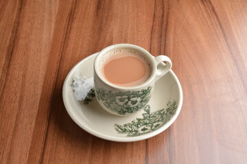 hot milk tea local Indian traditional teh Tarik in small cup on wood table hot beverage menu