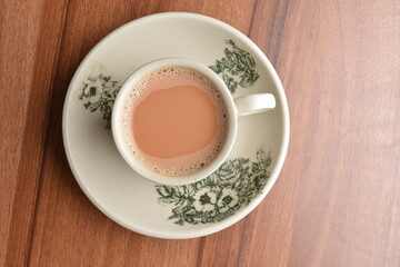 hot milk tea local Indian traditional teh Tarik in small cup on wood table hot beverage menu