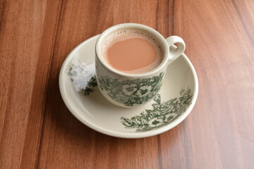 hot milk tea local Indian traditional teh Tarik in small cup on wood table hot beverage menu