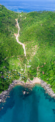 Coastline in Southern Thailand aerial drone uav high altitude landscape over the sea and land and mountains with sunny weather and clouds with turquoise water and copy space