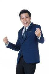 Young attractive asian business man wearing navy blue suit with white shirt and necktie smiling. Put his fists out celebrating and looking cheerful and successful on white background isolated