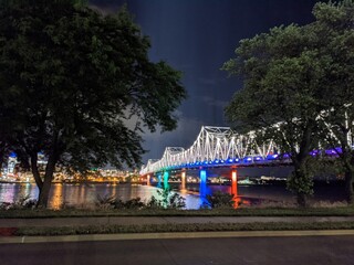 Obraz premium Rainbow lights colorful bridge at night water river