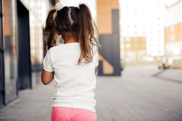 little girl in white t-shirt. space for your logo or design. Mockup for print