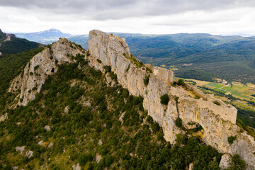 Fototapeta na wymiar Ruins of Cathar castle of Peyrepertuse perched on rocky ridge. France