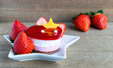 Sweet mini cake jelly cream and  Red Strawberry fresh fruit on wooden table.