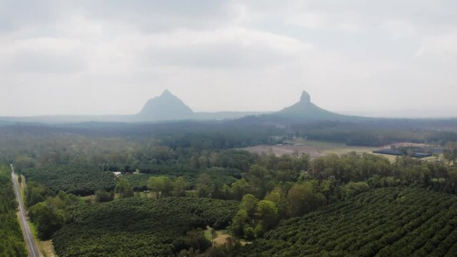 Mount Coonowrin And Mount Beerwah Obscure By Thick Fog In The Morning In The Glass House Mountains Range In Sunshine Coast Region, QLD, Australia. - aerial