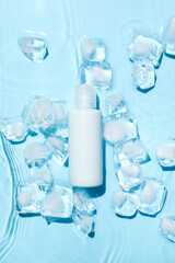 Bottle of cosmetic product and ice cubes in water on color background