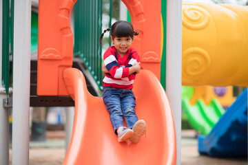 Fototapeta na wymiar Active little girl on playground