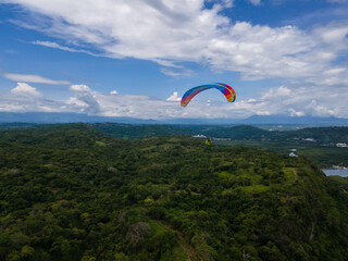 Beautiful aerial view of the extreme sport of paragliding on the Beach and mountains of Costa Rica 