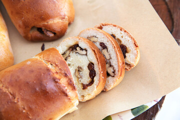 Bread with nuts being sliced on paper