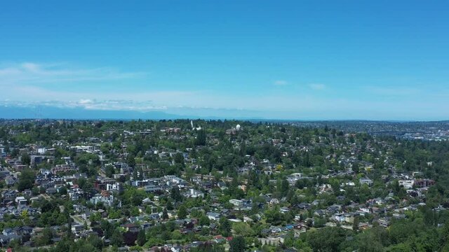 Drone flying over Madison Valley in Seattle with views of University of Washington, Fremont, Ballard, Queen Anne, Lake Union and Lake Washington.