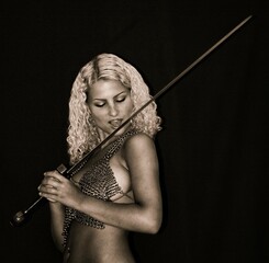 beautiful half-naked girl barbarian with a sword.  and chain mail on the bare chest