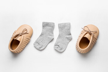 Baby shoes and socks on white background