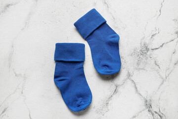 Baby socks on light background, closeup