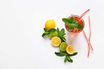Glass of tasty ice tea with citrus fruits on white background