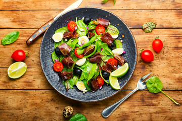 Delicious salad with vegetables, herbs and ham