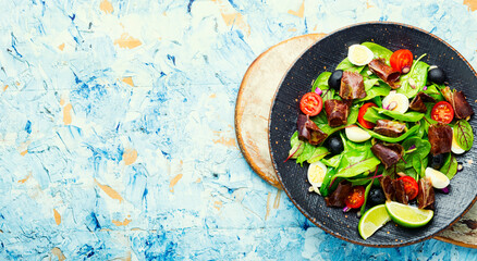 Delicious salad with vegetables, herbs and ham