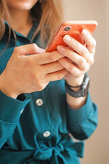 Young woman using smartphone to place an order in the online store. hands holding smartphone