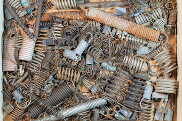 Many various rusty size compression springs. Close-up