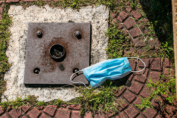 Hygiene mask on a cement block background.