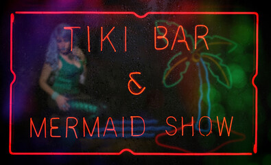 Neon Tiki Bar and Mermaid Show Neon Sign in Wet Window