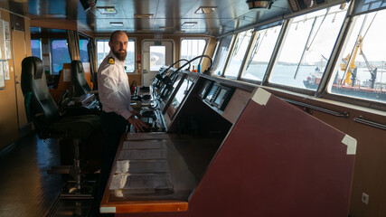 Navigational merchant officer watching keeping navigational watch on the bridge and watching ECDIS...