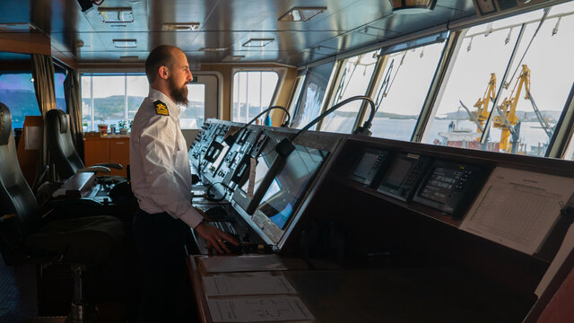 Navigational merchant officer watching keeping navigational watch on the bridge and watching ECDIS and radar