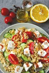Tabbouleh salad with feta cheese and vegetables. Traditional Arabic salad.