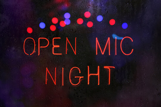 Open Mic Night Sign in Wet Rainy Window
