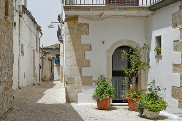 Obraz premium Bovino, Italy, 06/23/2021. A narrow street among the old houses of a medieval town with a Mediterranean style in the Puglia region.