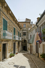 Fototapeta na wymiar A narrow street among the old houses of Bovino, a medieval village in the Puglia region.